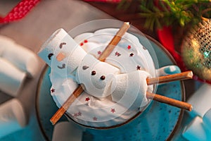 Christmas background with a marshmallow man lying in a mug with cocoa, in the background a Christmas tree with toys, a garland and