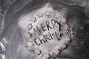 Christmas background. Merry Christmas written with flour and biscuits stars