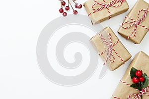 Christmas background, mock up with gift boxes wraped in craft paper, on white background. Winter holidays. Top view with copy