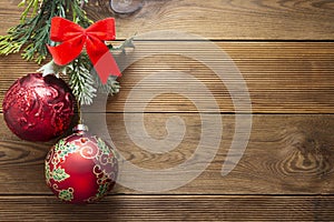 Christmas background mock up red baubles decoration with fir branches on wooden background, copy space