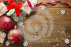 Christmas background mock up red baubles decoration with fir branches on wooden background, copy space