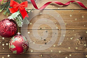 Christmas background mock up red baubles decoration with fir branches on wooden background, copy space