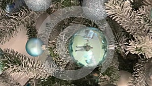Christmas background New Year Green Christmas tree with white snow on it blue and silver balls Nice pastel light color