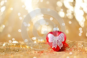 Christmas background, new year red heart decoration on gold glitter abstract blurred holiday bokeh background