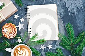 Christmas background with notepad and cuo of cappuccino.