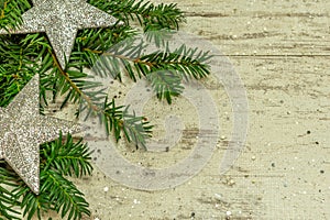 A christmas background on an old wooden board with firs, christmas balls