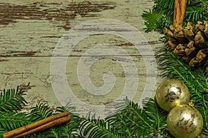 A christmas background on an old wooden board with firs, christmas balls