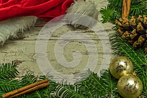 A christmas background on an old wooden board with firs, christmas balls