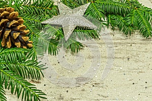 A christmas background on an old wooden board with firs, christmas balls