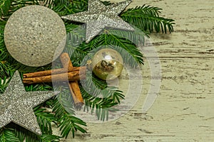 A christmas background on an old wooden board with firs, christmas balls