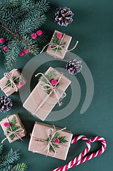 Christmas background. Packing gifts in vintage beige craft paper and natural decor.