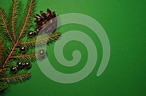 Christmas background. Pine branch, pine cone and golden balls.