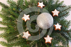 Christmas background with pine branches, cinnamon star cookies a