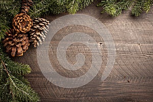 Christmas background with pine cones and green pine bough needles
