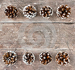 Christmas Background with Pine Cones on Rustic Wood