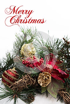 Christmas background with pine tree branch, pine cones, red flower and snow