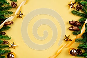 Christmas background, pine tree with xmas decoration on yellow background