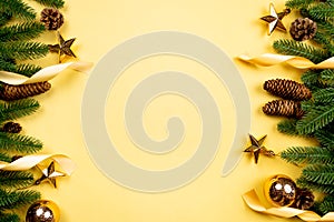 Christmas background, pine tree with xmas decoration on yellow background