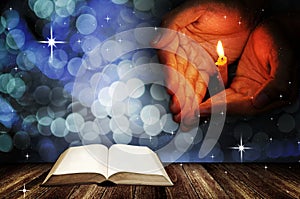 Christmas background, Prayer hand with candle and open blank book on deck