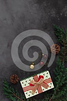 Christmas background with present box and decorations of tree branches and cones