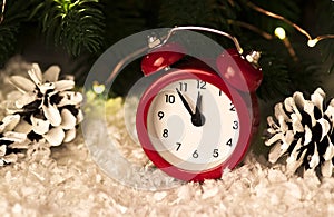 Christmas background with red alarm clock snowflakes cones and cones.