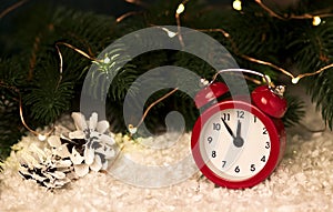 Christmas background with red alarm clock snowflakes cones and cones.