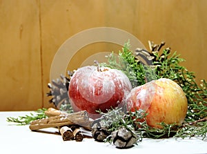 Christmas background red apples golden pineapples green pines and dried fruit