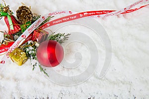 Christmas background with red bauble,snow and snowflakes