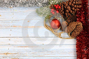 christmas background with red baubles, pinecones and tinsel