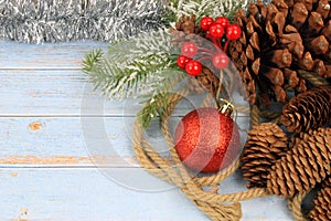 christmas background with red baubles, pinecones and tinsel