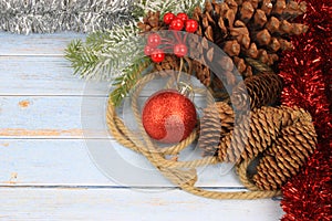 christmas background with red baubles, pinecones and tinsel