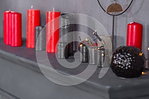 Christmas background with red and black candles on the fireplace