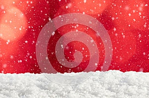 Christmas background with red bokeh, snowdrift and falling snow