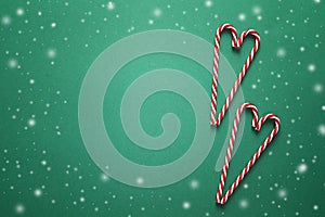 Christmas background with red candy canes in the shape of heart.