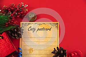 Christmas background on red, gifts and postcards close up