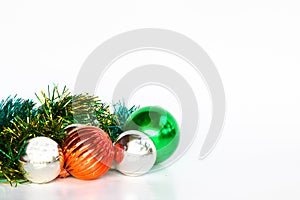Christmas background with a red ornament, Green ornament and Silver ornament on white background.