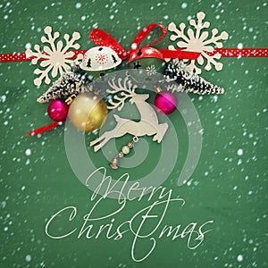 Christmas background with red silk traditional ribbon, white deer, evergreen tree and jingle bells.