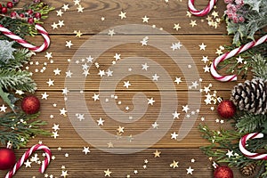 Christmas background with a red and white candie canes, fir branches, winter decoration. New year concept. Copy space.