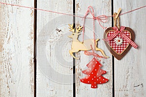 Christmas background with rustic decorations over white wooden board