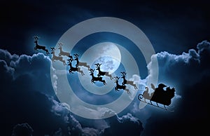 Christmas background. Silhouette of Santa Claus flying on a sleigh pulled by reindeer.