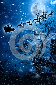 Christmas background. Silhouette of Santa Claus flying on a sleigh pulled by reindeer.