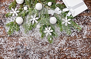 Christmas background with snow, baubles, fir and snowflakes