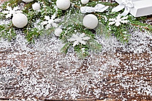 Christmas background with snow, baubles, fir and snowflakes