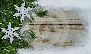 Christmas background with snow frame and snowflakes on green fir branches