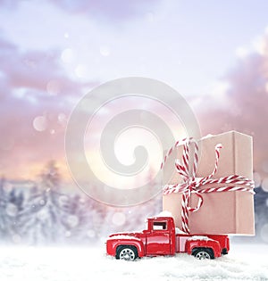 Christmas background with snow and retro car with gift box. Merry Christmas and happy New Year.