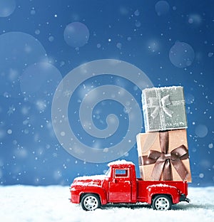 Christmas background with snow and retro car with gift box. .Merry Christmas and happy New Year greeting winter card