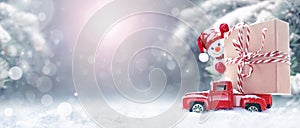 Christmas background with snow, snowman and retro red car with gift box. Merry Christmas and happy New Year.