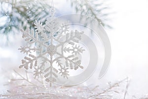 Christmas background, snowflakes on a blurred background, pine branches. Selective focus. Copy space