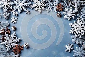 Christmas background with snowflakes and cones on light blue slate texture. Top view, copy space. Winter flatlay