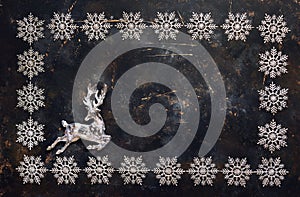 Christmas background with snowflakes and crystal deer. Top view with copy space